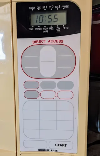 The control panel of a microwave, but all the buttons are blank
